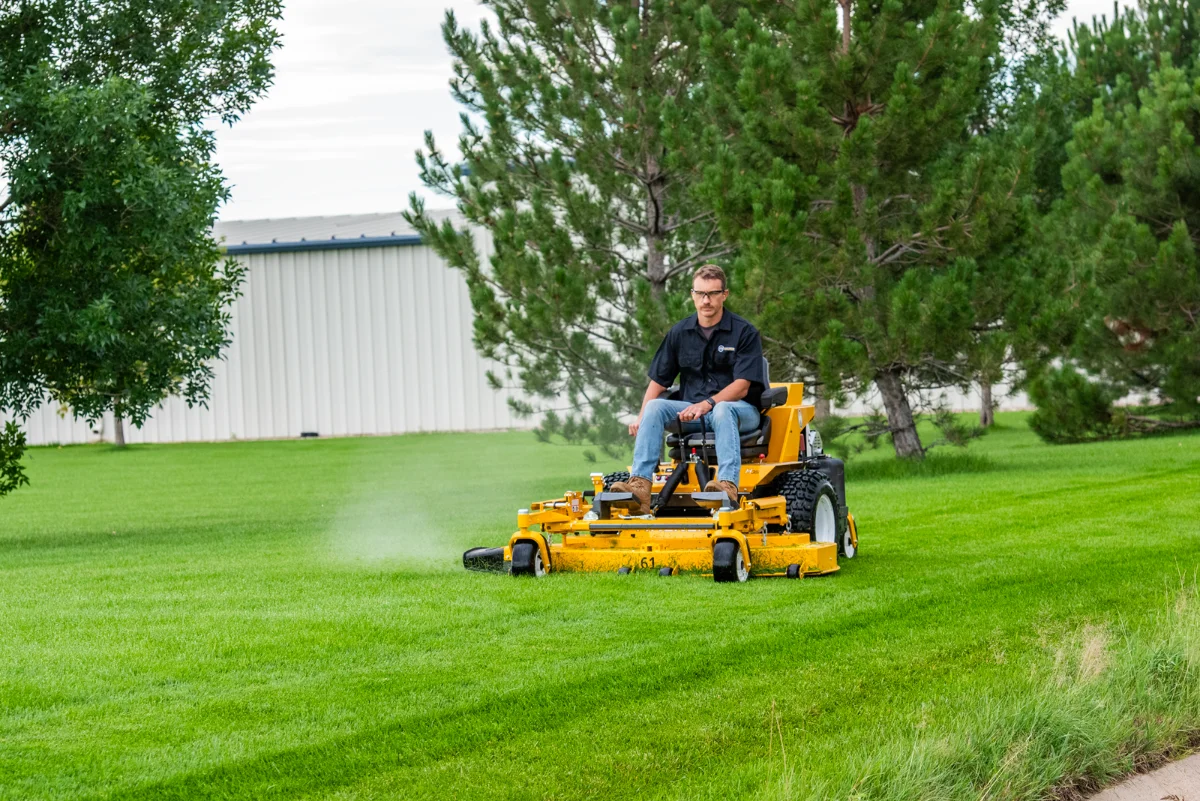 Walker out-front deck mower mowing a large lawn